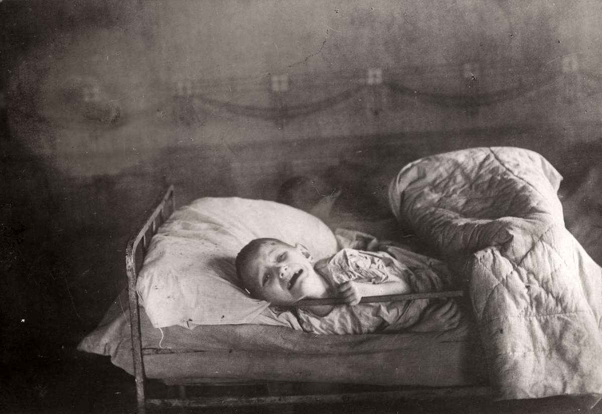 ребёнок в   кровати чёрное-белое  фото